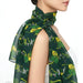 Onlewo 'Orchid Batik' silk cotton scarf detail — close-up of intricate batik-inspired orchid motifs in warm tropical tone