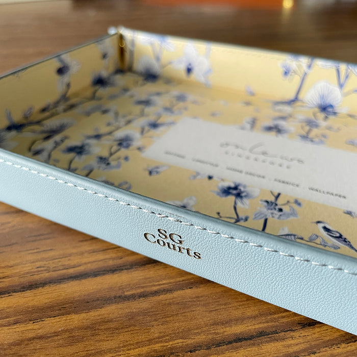 Onlewo 'Orchid Rhapsody' leather valet tray in use — elegant desk or bedside organiser with Singapore orchid design